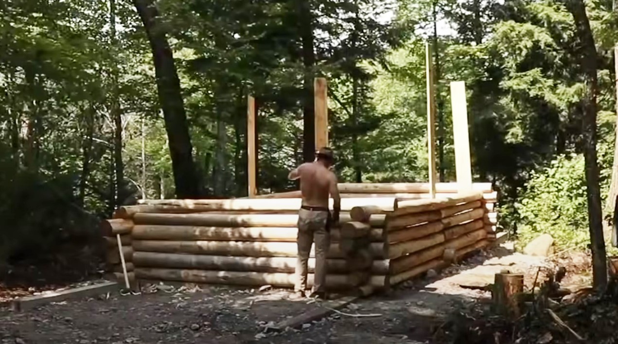 The man built a log cabin building completely alone in the middle of the forest. Here is the video of him doing it